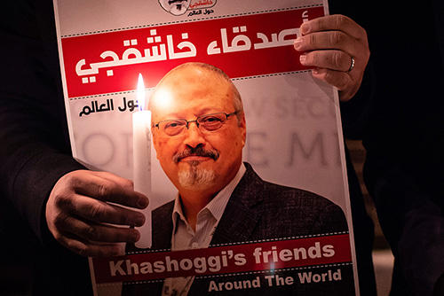 A protester holds a sign picturing Jamal Khashoggi at a gathering outside the Saudi consulate in Istanbul. (AFP/Yasin Akgul)