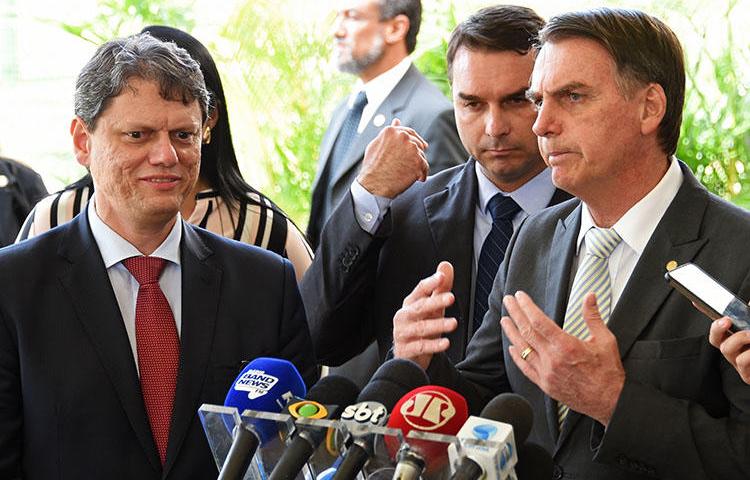 Brazil's new president, Jair Bolsonaro, right, talks to the press in Brasília on November 27. Journalists in Brazil say they expect the hostile climate experienced during the election to continue as Bolsonaro takes office. (AFP/Evaristo Sa)