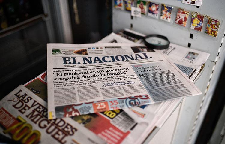 A copy of the last print edition of El Nacional, with a headline that reads 'El Nacional is a warrior and will keep on fighting,' on December 14. The daily is the latest Venezuelan publication forced to run online only because of limited access to newsprint. (AFP/Federico Parra)