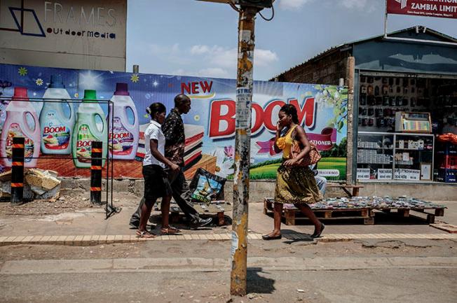 People walk in Lusaka's business district in November 2014. A journalist was jailed in the city in December 2018 for contempt of court. (AFP/ Gianluigi Guercia)