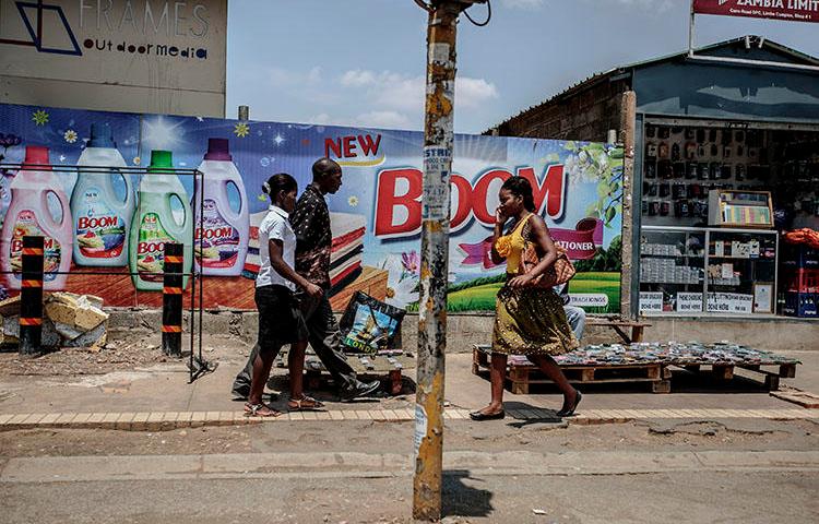 People walk in Lusaka's business district in November 2014. A journalist was jailed in the city in December 2018 for contempt of court. (AFP/ Gianluigi Guercia)