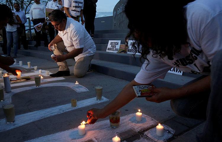 Periodistas prenden velas para conmemorar el primer aniversario luctuoso del asesinato de la periodista mexicana Miroslava Breach, en marzo. La delincuencia y la política son fuentes peligrosas para los periodistas de México. (Reuters/José Luis González)