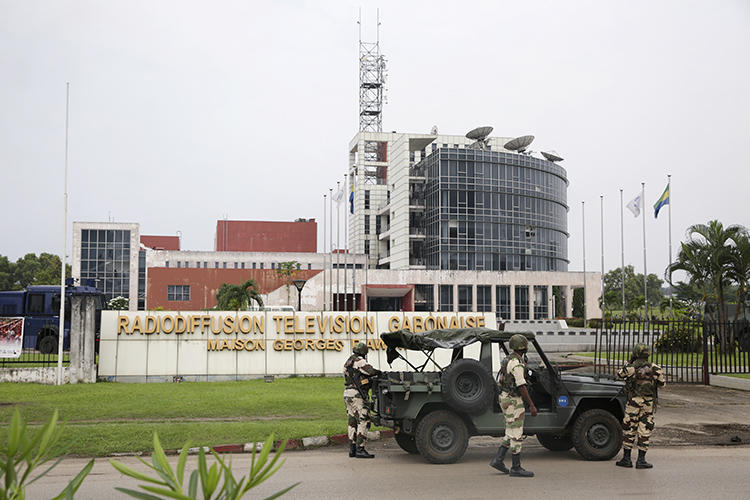 Gabonese soldiers stand in front of the headquarters of the national broadcaster in Libreville on January 7, 2019, after a failed coup. Gabon shut down the internet and broadcasting services following the coup attempt. (AFP/Steve Jordan)