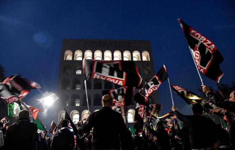 Members of the Italian far-right political party Forza Nuova wave flags during a demonstration on November 4, 2017, in central Rome. On January 7, 2019, members of Forza Nouva and other extremist groups attacked two reporters covering an event in Rome. (AFP/Andreas Solaro)