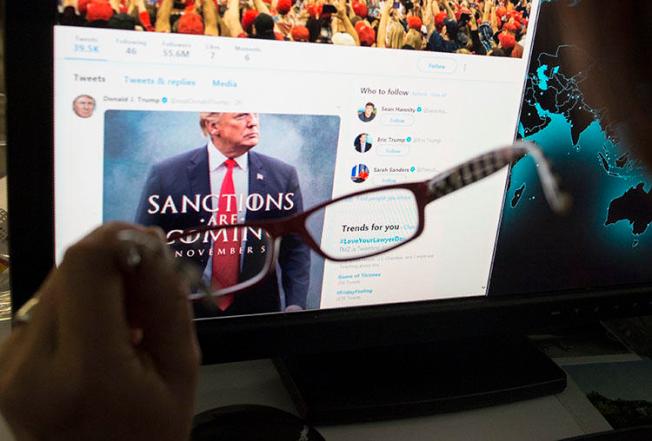 A woman looks at the Twitter feed of President Donald Trump in November 2018. Trump uses Twitter to make policy announcements and also to rail against critical press coverage. (STF/AFP)