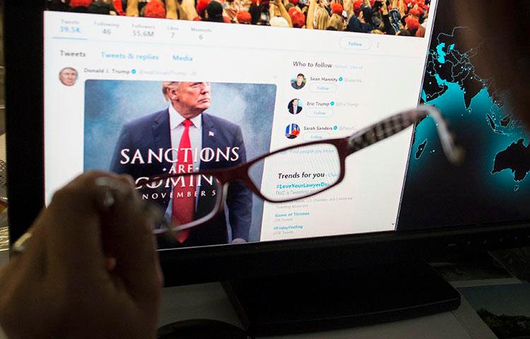 A woman looks at the Twitter feed of President Donald Trump in November 2018. Trump uses Twitter to make policy announcements and also to rail against critical press coverage. (STF/AFP)