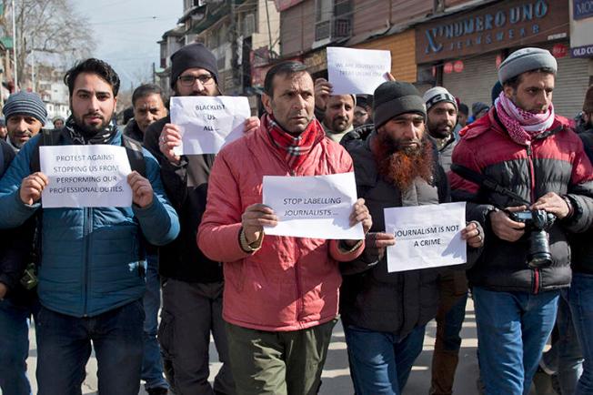 Kashmiri journalists hold placards during a protest march in Srinagar, Indian controlled Kashmir, on Saturday, January 26, 2019. Dozens of journalists marched in protest after authorities barred 10 journalists from entering the venue of India's Republic Day parade in the disputed region's main city. (Dar Yasin/AP)
