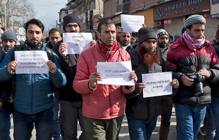 Kashmiri journalists hold placards during a protest march in Srinagar, Indian controlled Kashmir, on Saturday, January 26, 2019. Dozens of journalists marched in protest after authorities barred 10 journalists from entering the venue of India's Republic Day parade in the disputed region's main city. (Dar Yasin/AP)