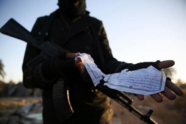 A February 2016 photo taken by Mohamed Ben Khalifa shows a member of the Libyan security forces with a document in Arabic describing weaponry found at the site of U.S. airstrikes on an Islamic State camp in Libya. Freelance photojournalist Ben Khalifa was killed during clashes on January 19. (AP/Mohamed Ben Khalifa/File)