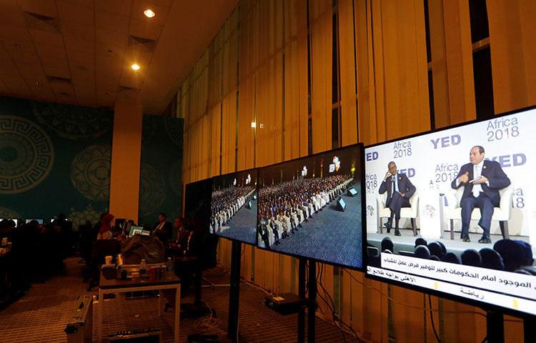 Egyptian President Abdel Fattah al-Sisi is seen on a television screen at the press center during the Africa 2018 Forum in Sharm el-Sheikh, Egypt, on December 8, 2018. An Egyptian TV presenter was sentenced to prison for an interview with a gay man on January 20, 2019. (Reuters/Amr Abdallah Dalsh)