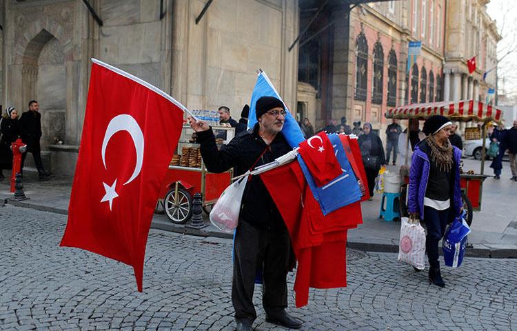 A street vendor in Istanbul sells Turkish flags on December 31. Turkey's media regulator has fined two news broadcasters over their critical commentary. (Reuters/Murad Sezer)