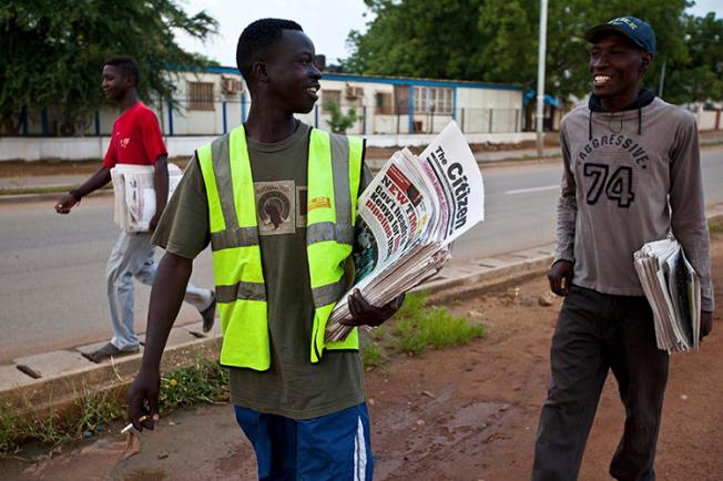 Newspaper vendors chat on their way to sell newspapers in Juba, South Sudan. Recently, the South Sudanese government has attempted to restrict local newspapers' ability to cover the ongoing political crisis in neighboring Sudan. (Adriane Ohanesian/Reuters)