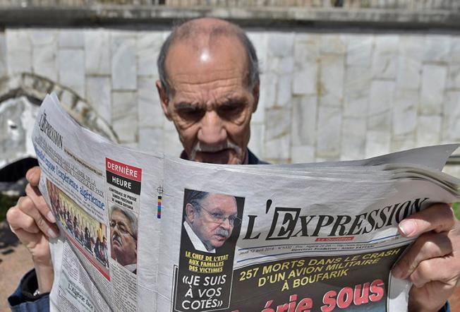 An Algerian man reads a newspaper in the capital, Algiers, on April 12, 2018. Adlène Mellah, founder of online news outlets Dzair Presse and Algerie-Direct, was recently handed a six-month suspended prison sentence in Algiers (Ryad Kramdi/AFP)