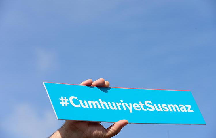 A sign reading 'Cumhuriyet will not be silent' is held during a protest outside Istanbul's court house in September 2017. An appeals court in February upheld the convictions of six staff at the paper. (AFP/Yasin Akgul)