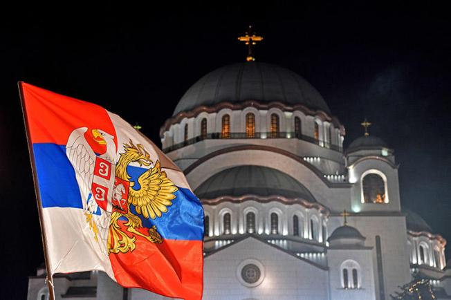 A Serbian flag in front of Saint Sava Church in Belgrade. Police are investigating after a threatening letter was sent to a Serbian TV station. (AFP/Andrej Isakovic)