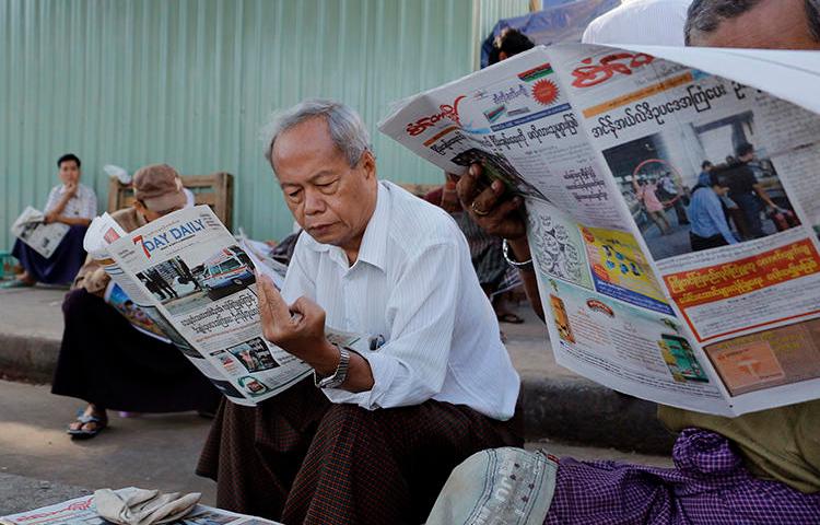 People read local newspapers in Yangon, Myanmar, on January 30, 2017. Two journalists working in Kachin stat were recently detained and assaulted by a local mining company there. (Thein Zaw/AP)