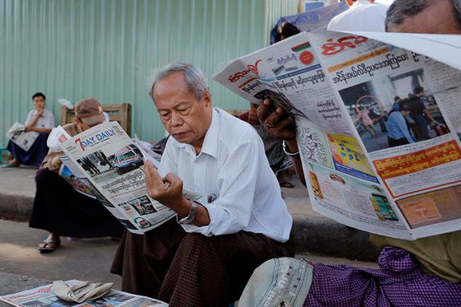 People read local newspapers in Yangon, Myanmar, on January 30, 2017. Two journalists working in Kachin stat were recently detained and assaulted by a local mining company there. (Thein Zaw/AP)