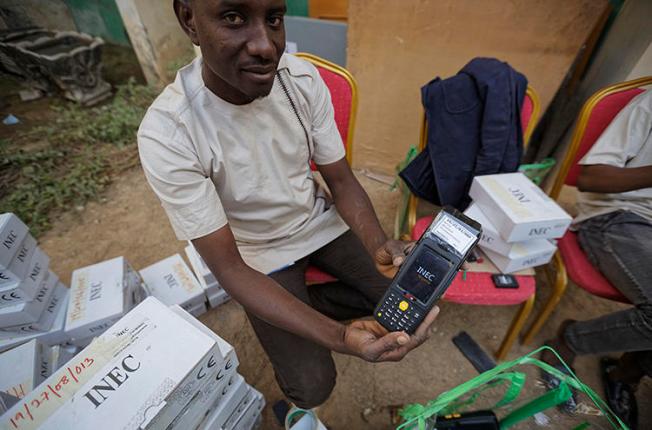 An electoral worker prepares identity card and biometric verification readers, at the offices of the Independent National Electoral Commission in Kano, northern Nigeria, on February 14, 2019. CPJ joined a call for Nigeria to ensure that internet and social media services remain connected during the upcoming elections. (AP Photo/Ben Curtis)