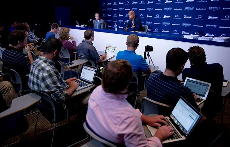 A Penn State news conference in 2014. A sports journalist who helped break the story about convicted Penn State coach Jerry Sandusky says she abandoned Twitter because of threatening messages. (AP/Matt Rourke)