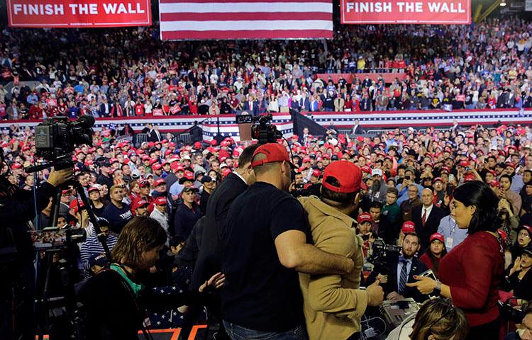 A man is restrained after he began shoving members of the media during a rally for President Donald Trump at the El Paso County Coliseum in El Paso, Texas, on February 11, 2019. (AP Photo/Eric Gay)
