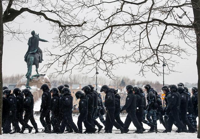 Police walk past a monument to Peter the Great during a rally of opposition supporters in Saint Petersburg on February 10. Jailed Russian journalist Igor Rudnikov is due in court in the city on February 14. (Reuters/Anton Vaganov)