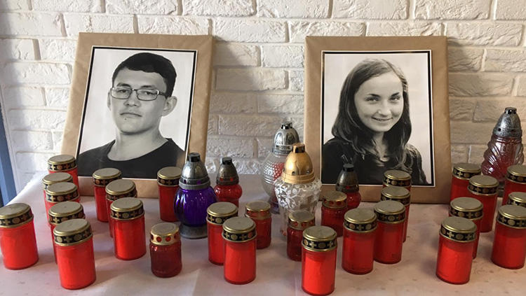 Photos of Ján Kuciak and Martina Kušnírová are set on a table at the Bratislava offices of Aktuality. One year after the double murder, Kuciak's colleagues say they are committed to continuing Kuciak's work. (CPJ)