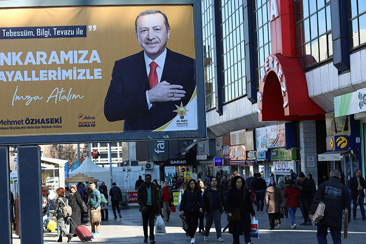 A campaign billboard for the ruling Justice and Development Party (AKP), pictured in Ankara on March 8. Police on March 19 detained a reporter and questioned her about her work in the capital. (AFP/Adem Altan)