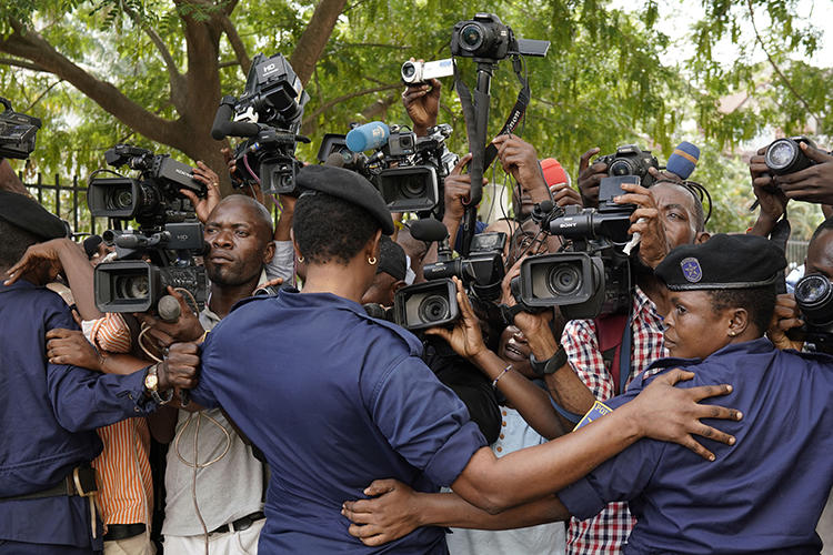 Congolese police officers hold back members of the media in Kinshasa, Democratic Republic of Congo, on January 12, 2019. Journalist Steeve Mwanyo Iwewe was recently fined and sentenced to one year in jail for insulting the governor of Équateur province. (Jerome Delay/AP)