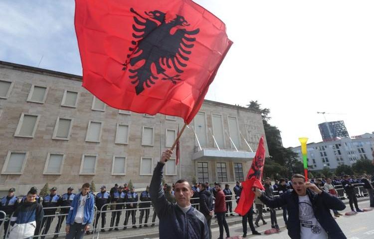 Protesters wave Albanian flags in Tirana, Albania, on March 16, 2019. A British journalist living in Albania has recently been attacked in a smear campaign after she gave comments on the RT network. (Florion Goga/Reuters)