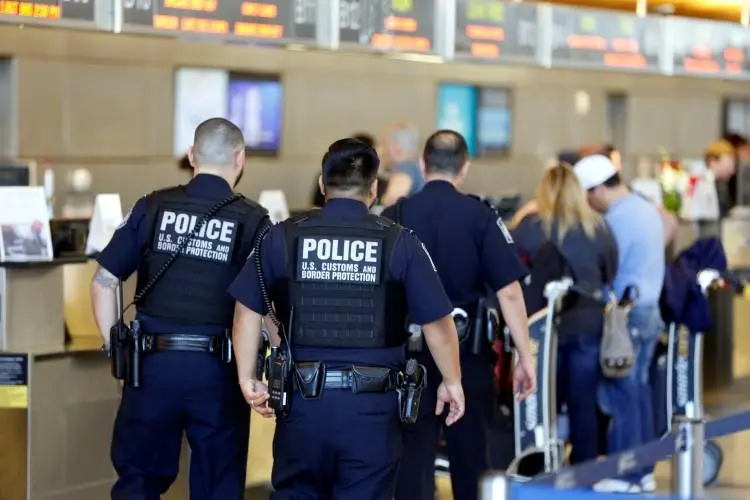 Customs and Border Protection agents pictured at Los Angeles International Airport in January 2017. The agency's power to search electronic devices without warrant has serious implications for press freedom. (Reuters/Patrick T. Fallon)