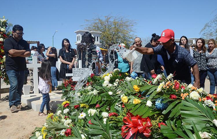 Flowers cover the casket of Santiago Barroso, a Mexican radio journalist shot dead in Sonora state in March. (Reuters/Cristian Torres)