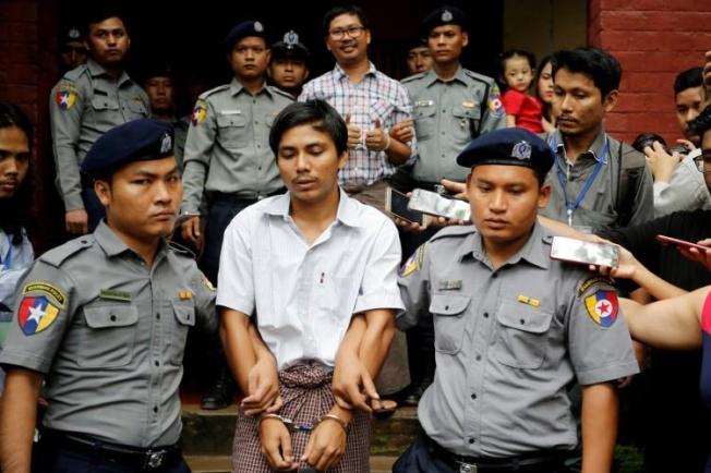 Detained Reuters journalists Kyaw Soe Oo and Wa Lone are escorted by police as they leave after a court hearing in Yangon, Myanmar, on August 20, 2018. The journalists will have their appeal heard at the Myanmar Supreme Court on March 26. (Ann Wang/Reuters)