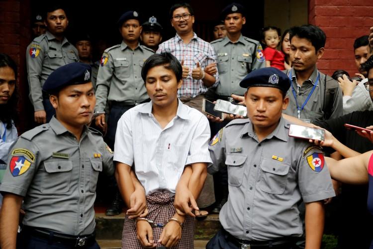 Detained Reuters journalists Kyaw Soe Oo and Wa Lone are escorted by police as they leave after a court hearing in Yangon, Myanmar, on August 20, 2018. The journalists will have their appeal heard at the Myanmar Supreme Court on March 26. (Ann Wang/Reuters)
