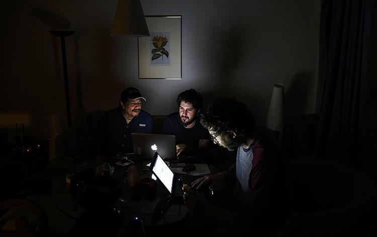 A photojournalist works in a Caracas hotel room during the third day of a massive power outage. Alongside power cuts, journalists must navigate internet blackouts as Nicolás Maduro's government attempts to silence the news. (AFP/Juan Barreto)