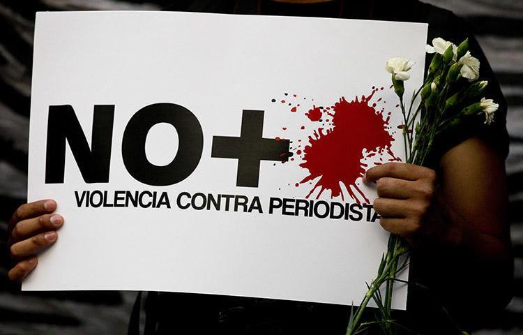 No more violence against journalists," reads a sign held by a protester during a demonstration outside the Interior Ministry in Mexico City on May 16, 2017. (AP/Rebecca Blackwell)