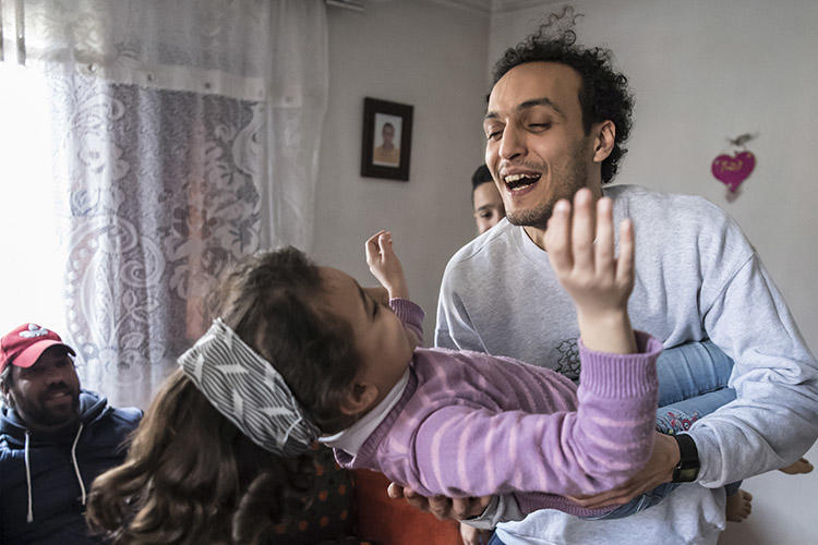 Egyptian photojournalist Shawkan plays with his niece at his home in Cairo after being released from prison on March 4. (AFP/Khaled Desouk)