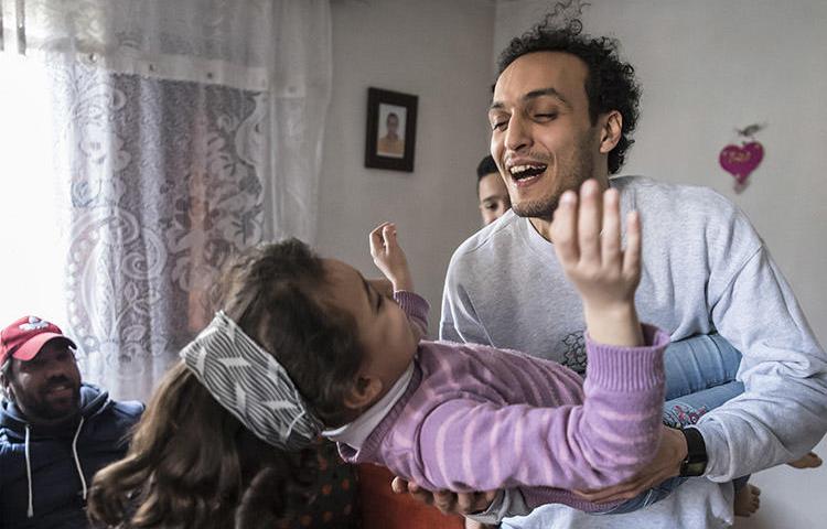 Egyptian photojournalist Shawkan plays with his niece at his home in Cairo after being released from prison on March 4. (AFP/Khaled Desouk)