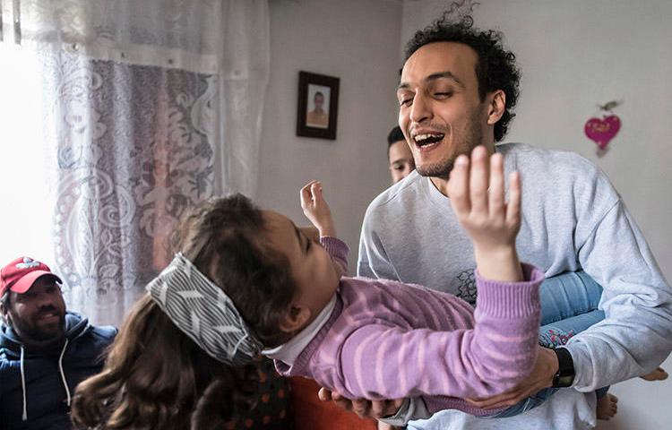 Egyptian photojournalist Shawkan plays with his niece at his home in Cairo after being freed from prison on March 4. As a condition of his release , Shawkan must return to custody every day at 6 p.m. (AFP/Khaled Desouk)