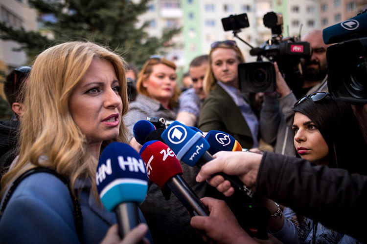 Slovakia's president-elect Zuzana Čaputová, pictured talking to the press outside a polling station in Pezinok on March 30. CPJ and other rights organizations are calling on the newly elected leader to ensure the safety of journalists. (AFP/Vladimir Simicek)