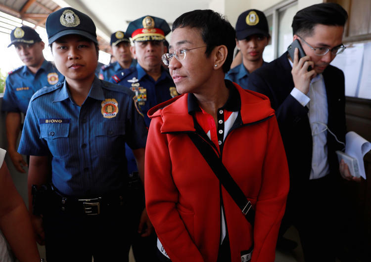 Rappler Founder and Executive Editor Maria Ressa is escorted by police after posting bail in Pasig Regional Trial Court in Pasig City, Philippines, on March 29, 2019. (Reuters/Eloisa Lopez)