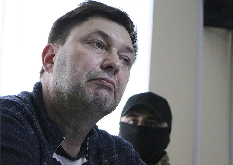 Russian journalist Kirill Vyshinskiy listens to a lawyer in a court room in Kherson, Ukraine, on May 17, 2018. His trial, for treason, began yesterday. (AP/Victor Platov)