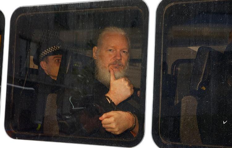 WikiLeaks founder Julian Assange is seen in a police van after he was arrested in London on April 11, 2019. (Reuters/Henry Nicholls)