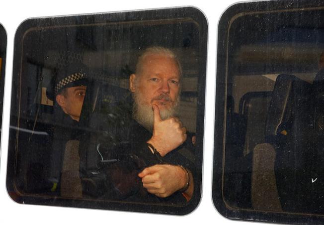 WikiLeaks founder Julian Assange is seen in a police van after he was arrested in London on April 11, 2019. (Reuters/Henry Nicholls)