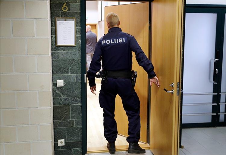 A police officer is seen in a court in Tampere, Finland, on July 5, 2016. A journalist in Oulou was recently convicted on criminal defamation charges. (Lehtikuva/Kalle Parkkinen/via Reuters)