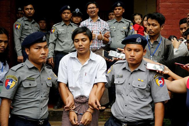 Police escort Reuters journalist Kyaw Soe Oo and Wa Lone from a court hearing in Yangon in August 2018. The Myanmar Supreme Court has upheld their seven-year conviction. (Reuters/Ann Wang)