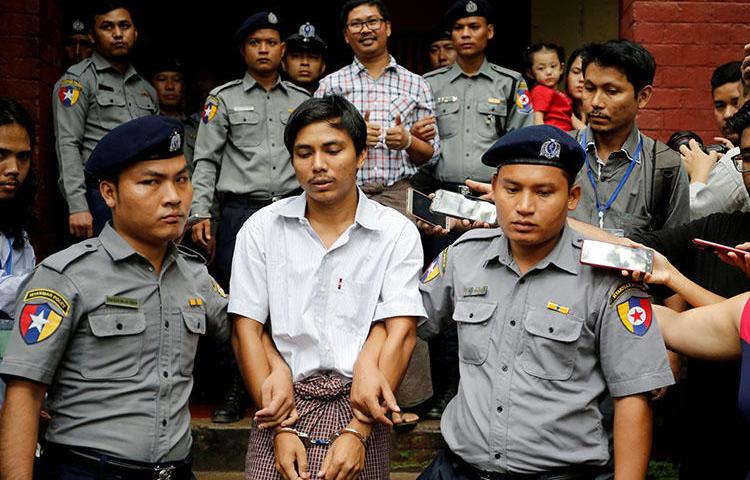 Police escort Reuters journalist Kyaw Soe Oo and Wa Lone from a court hearing in Yangon in August 2018. The Myanmar Supreme Court has upheld their seven-year conviction. (Reuters/Ann Wang)
