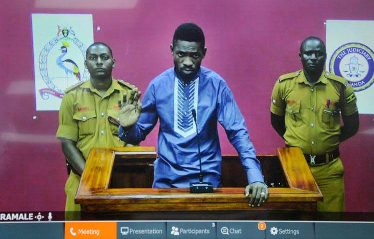 Ugandan pop star and opposition figure Bobi Wine appears for his bail application via a video link from prison, on a television screen in a court in Kampala, Uganda, on May 2, 2019. Uganda's media regulator suspended staff from 13 broadcast outlets for covering his arrest. (AP/Ronald Kabuubi)