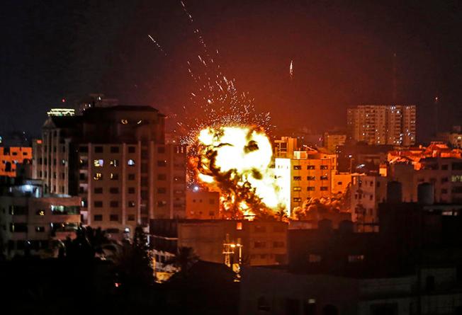 The explosion from an Israeli airstrike is seen in Gaza City on May 4, 2019. A building housing the Turkish Anadolu news agency's Gaza office was destroyed by Israeli forces that evening. (AFP/Mahmud Hams)