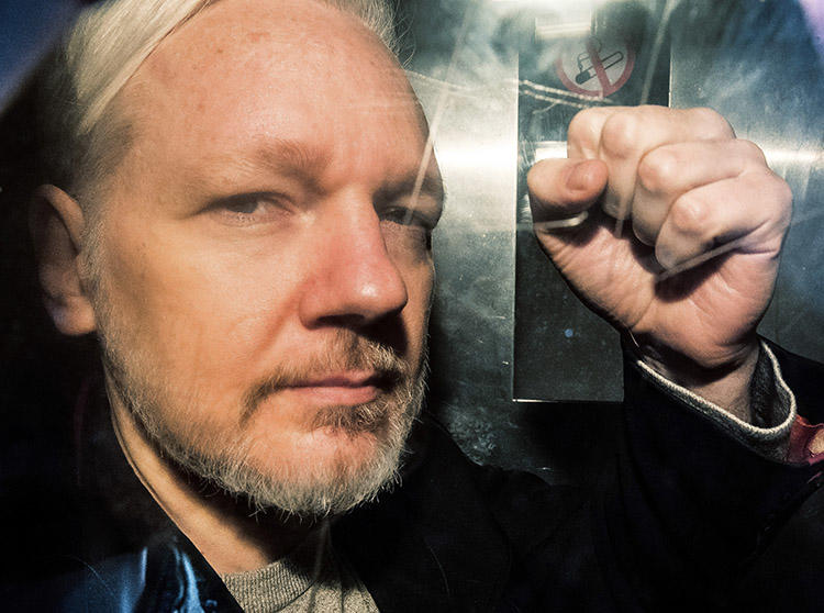 WikiLeaks founder Julian Assange, pictured in a prison van in the U.K. on May 1, 2019. The U.S. has disclosed charges under the Espionage Act against Assange. (AFP/Daniel Leal-Olivas)