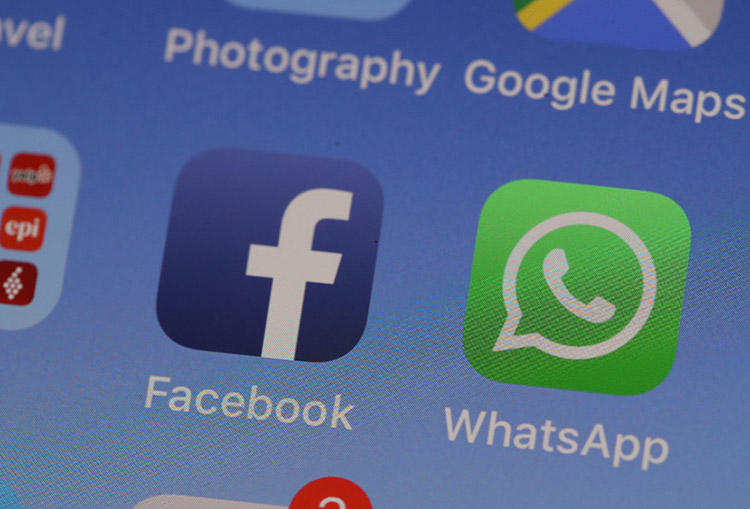 The WhatsApp messaging app is displayed on an iPhone in May 2019. WhatsApp is advising users to update the messaging app after a vulnerability was identified. (AFP/Justin Sullivan/Getty Images)